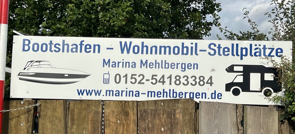 Entrance sign of the Mehlbergen Marina for the boat harbour and motorhome pitches