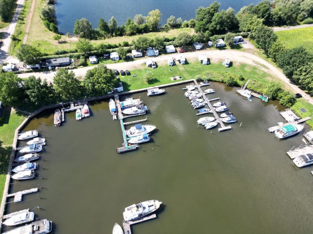 Aerial view of the Mehlbergen marina with the harbour basin, boat moorings and pitches